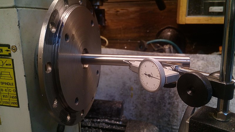 A spindle being tested for runout via dial indicator